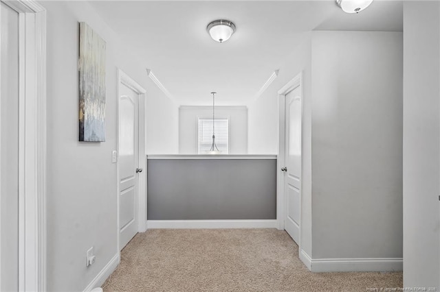 corridor featuring carpet and baseboards