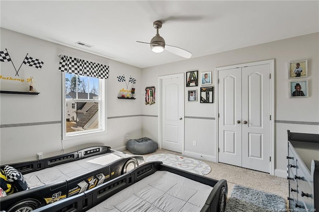 bedroom with carpet, a closet, visible vents, a ceiling fan, and baseboards