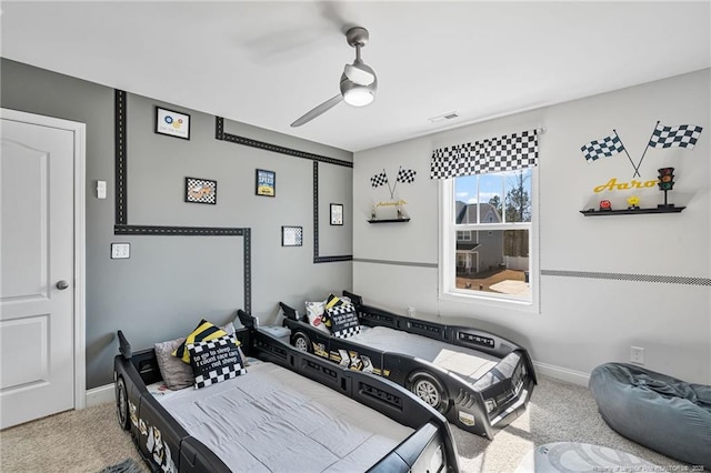 carpeted bedroom featuring ceiling fan, visible vents, and baseboards