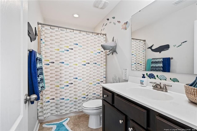 bathroom with visible vents, vanity, toilet, and tile patterned floors