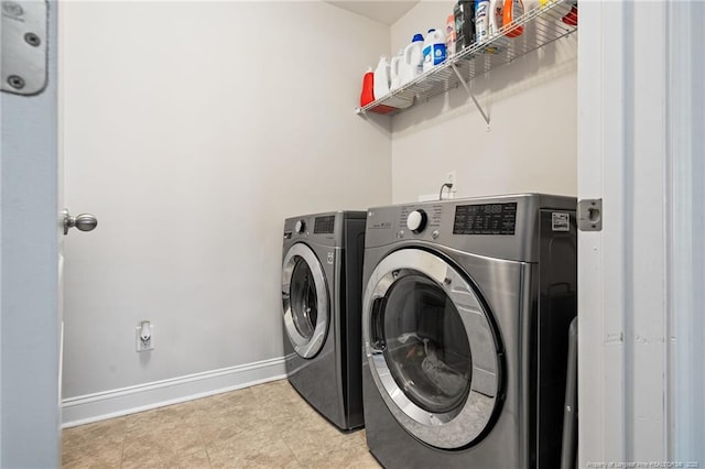 laundry room featuring laundry area, baseboards, and washer and dryer