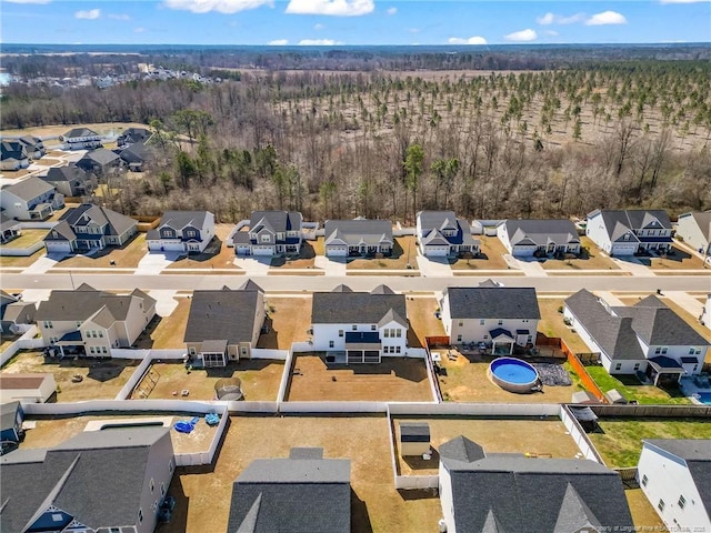 birds eye view of property with a residential view and a forest view