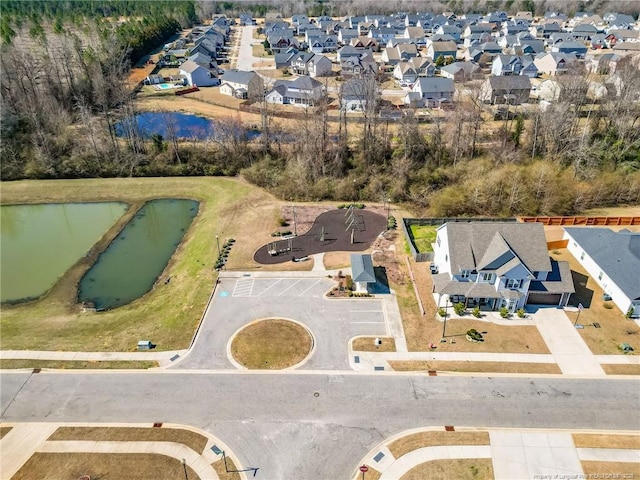 birds eye view of property with a water view and a residential view