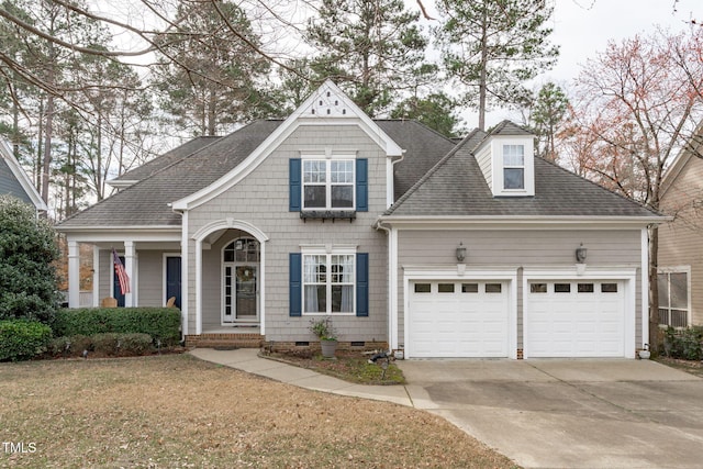 view of front of property with roof with shingles, concrete driveway, covered porch, crawl space, and a garage