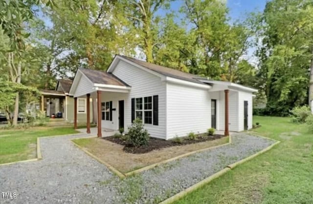 view of side of home featuring a yard