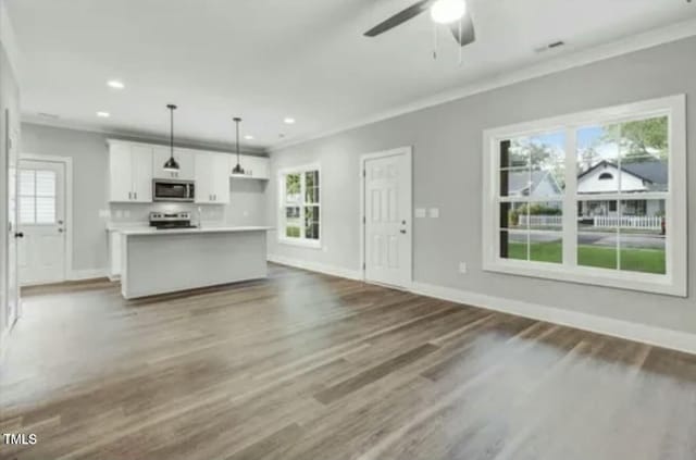 unfurnished living room with plenty of natural light and baseboards