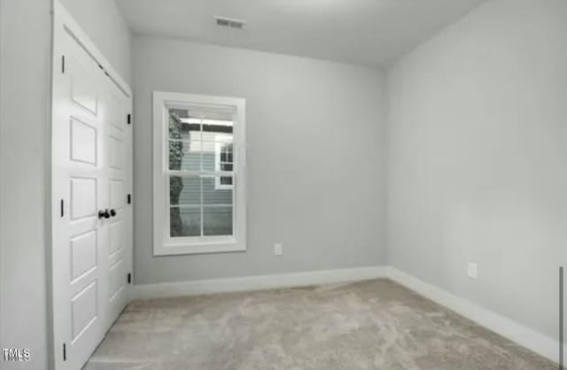 empty room with visible vents and baseboards