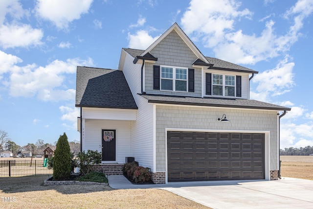 craftsman house with roof with shingles, concrete driveway, entry steps, fence, and a garage