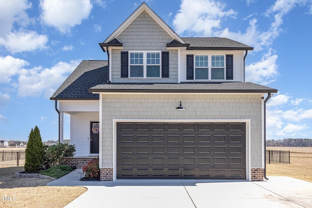 craftsman-style house with driveway, roof with shingles, an attached garage, and fence