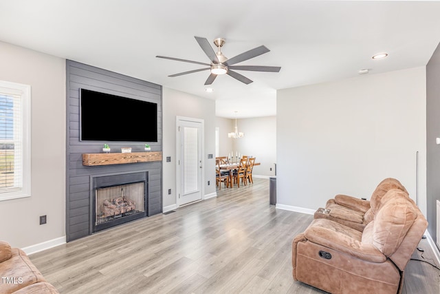 living area featuring ceiling fan, recessed lighting, a large fireplace, baseboards, and light wood finished floors