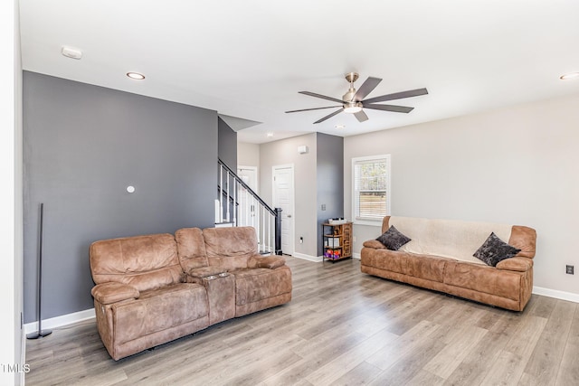 living room with light wood-style floors, stairs, baseboards, and recessed lighting