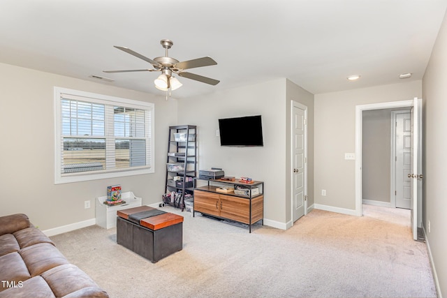 carpeted living area with visible vents, a ceiling fan, and baseboards