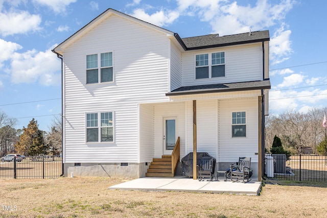 back of property with entry steps, crawl space, fence, a yard, and a patio area