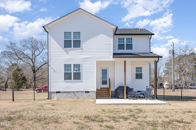 rear view of house with entry steps, fence, a yard, crawl space, and a patio area