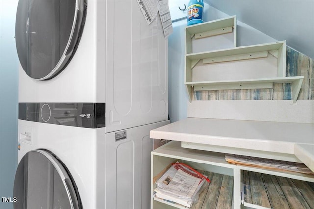 laundry room featuring stacked washer / drying machine and laundry area