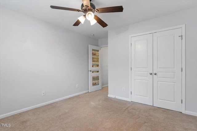 unfurnished bedroom featuring a closet, baseboards, and carpet