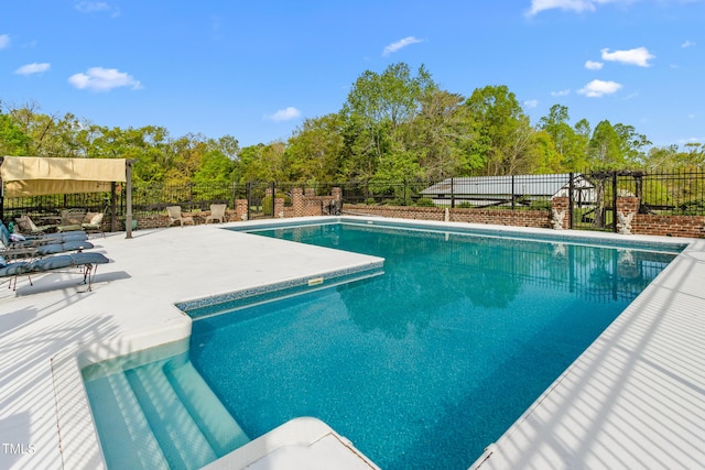view of pool featuring a patio area, a fenced in pool, and fence