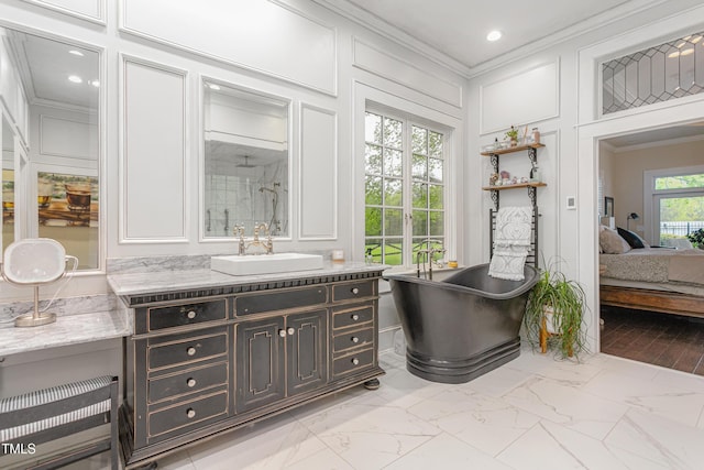 ensuite bathroom with a soaking tub, a decorative wall, marble finish floor, and ornamental molding