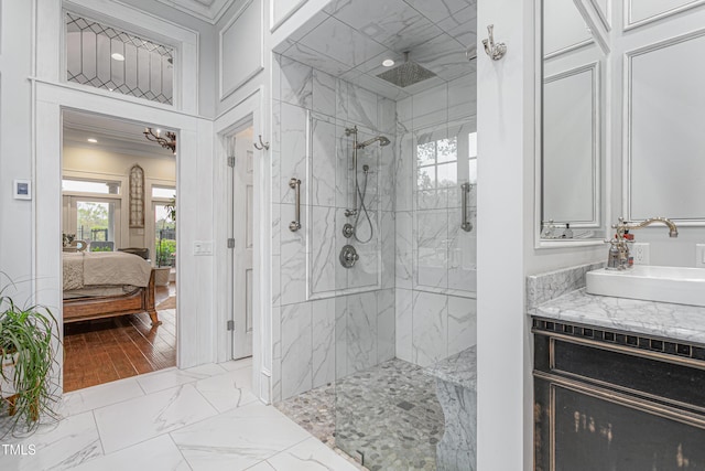 bathroom featuring marble finish floor, a marble finish shower, ensuite bathroom, and vanity