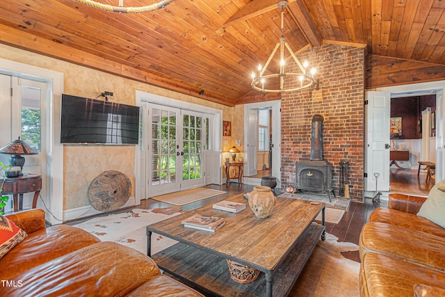 living room with a wood stove, a chandelier, hardwood / wood-style flooring, wood ceiling, and vaulted ceiling with beams