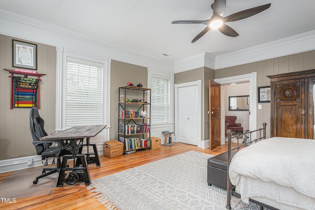 bedroom with ornamental molding, baseboards, a ceiling fan, and light wood-style floors