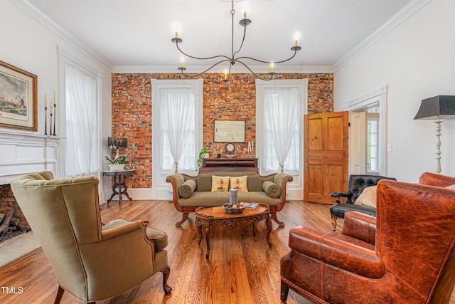 living room featuring a notable chandelier, crown molding, and wood finished floors