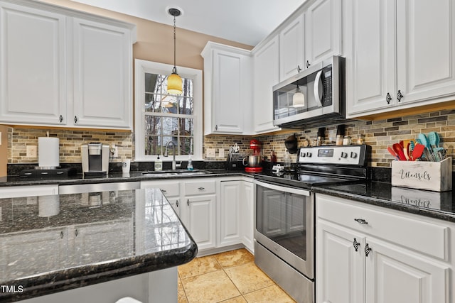 kitchen featuring a sink, decorative backsplash, white cabinetry, and stainless steel appliances