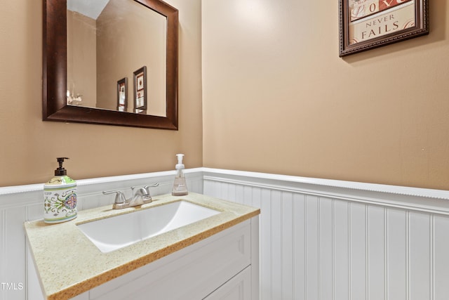 bathroom featuring a wainscoted wall and vanity