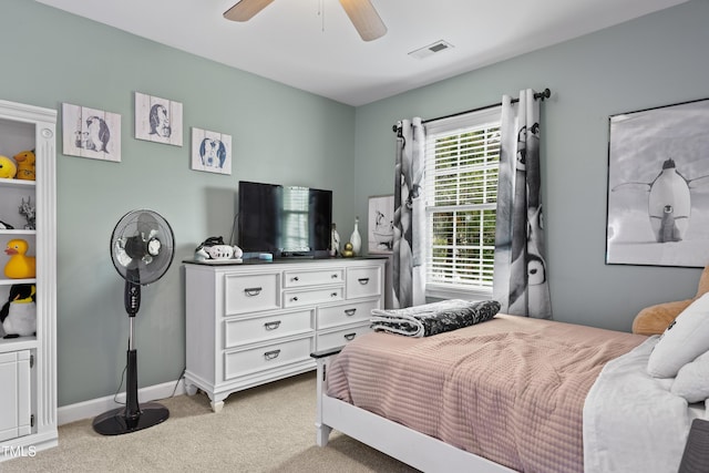 bedroom featuring light carpet, visible vents, a ceiling fan, and baseboards