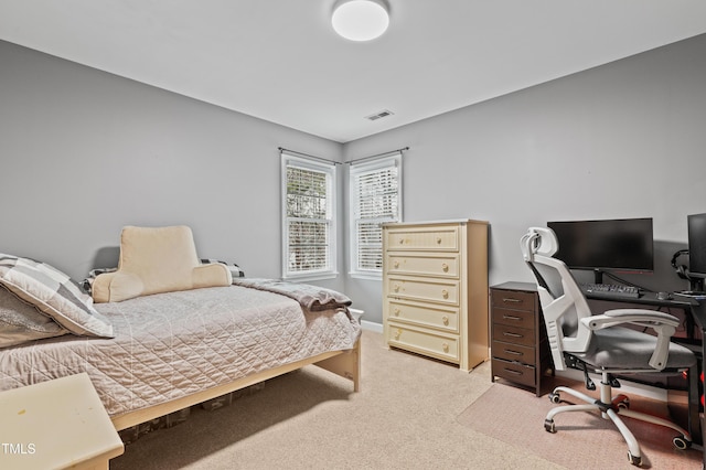 bedroom featuring visible vents, light carpet, and baseboards