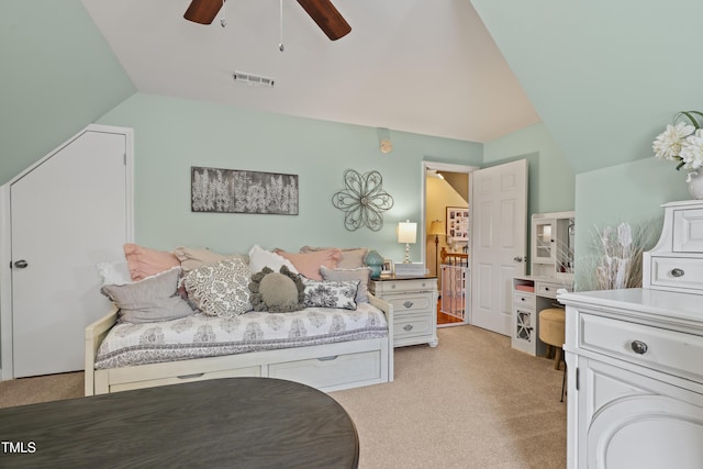 bedroom featuring visible vents, light colored carpet, a ceiling fan, and vaulted ceiling