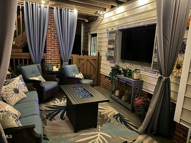 sitting room with wooden walls and beamed ceiling