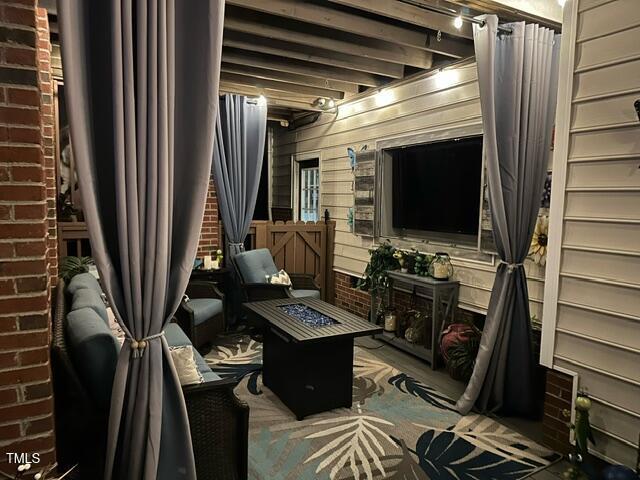 sitting room featuring wooden walls and brick wall