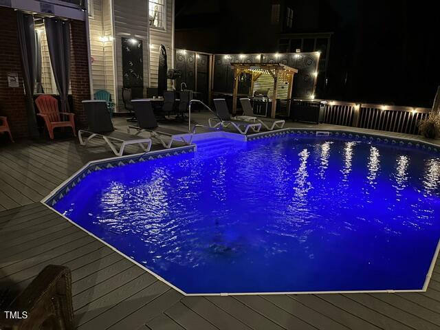 outdoor pool featuring a wooden deck