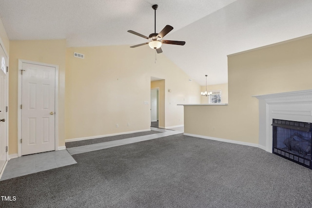 unfurnished living room featuring a fireplace, visible vents, vaulted ceiling, and carpet flooring