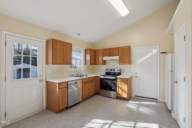 kitchen with under cabinet range hood, stainless steel appliances, a sink, visible vents, and light countertops