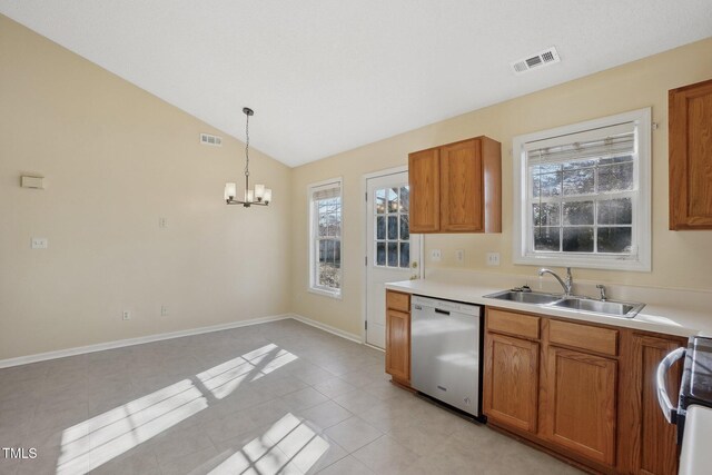 kitchen with visible vents, lofted ceiling, dishwashing machine, brown cabinets, and a sink