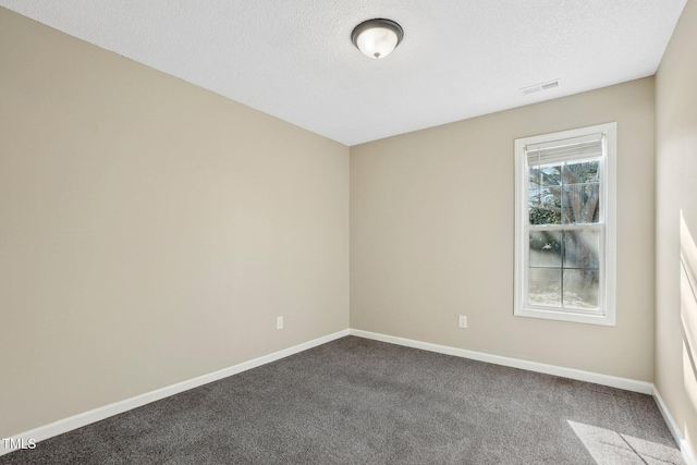 unfurnished room featuring carpet, visible vents, a textured ceiling, and baseboards