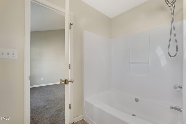 full bath featuring shower / tub combination and baseboards