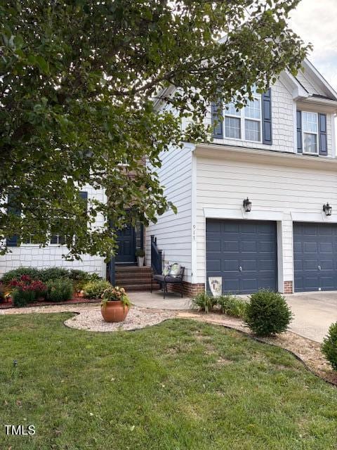 917 Widewaters Pkwy, Knightdale, NC 27545 - view of front facade with a front yard, concrete driveway, and an attached garage