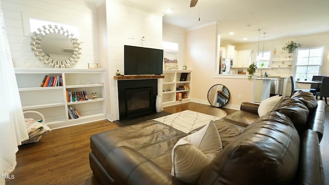 living room featuring a fireplace, recessed lighting, ornamental molding, ceiling fan, and wood finished floors