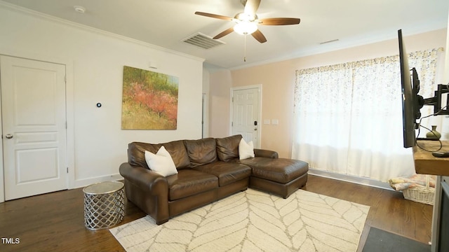 living area with ceiling fan, ornamental molding, wood finished floors, and visible vents