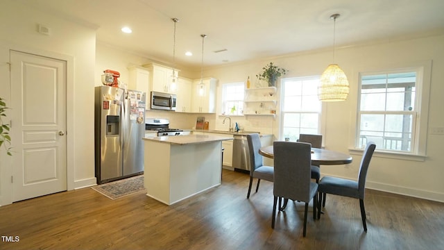 kitchen featuring stainless steel appliances, dark wood-type flooring, a kitchen island, and open shelves