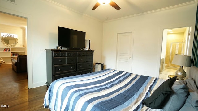 bedroom featuring ensuite bathroom, ceiling fan, wood finished floors, baseboards, and crown molding