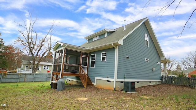 rear view of property featuring crawl space, a sunroom, fence, and cooling unit