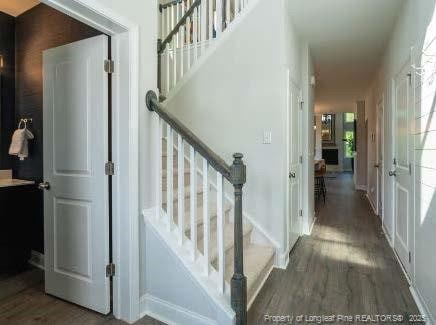 stairs featuring wood finished floors