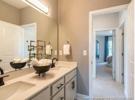 full bath featuring double vanity and a sink