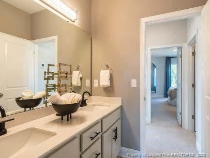 bathroom with double vanity and a sink