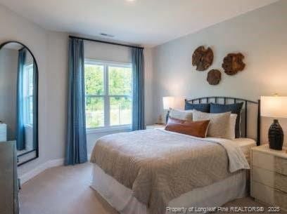 bedroom with carpet and baseboards