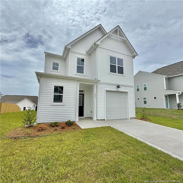 659 Union St, Home, Raeford, NC 28376 - view of front of house featuring board and batten siding, driveway, a front lawn, and an attached garage